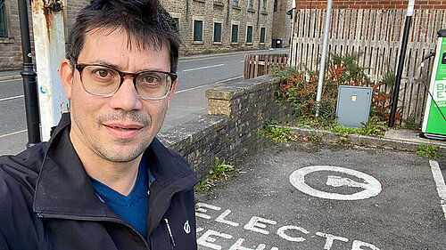 Sam Al-Hamdani at a public car charger in Lees